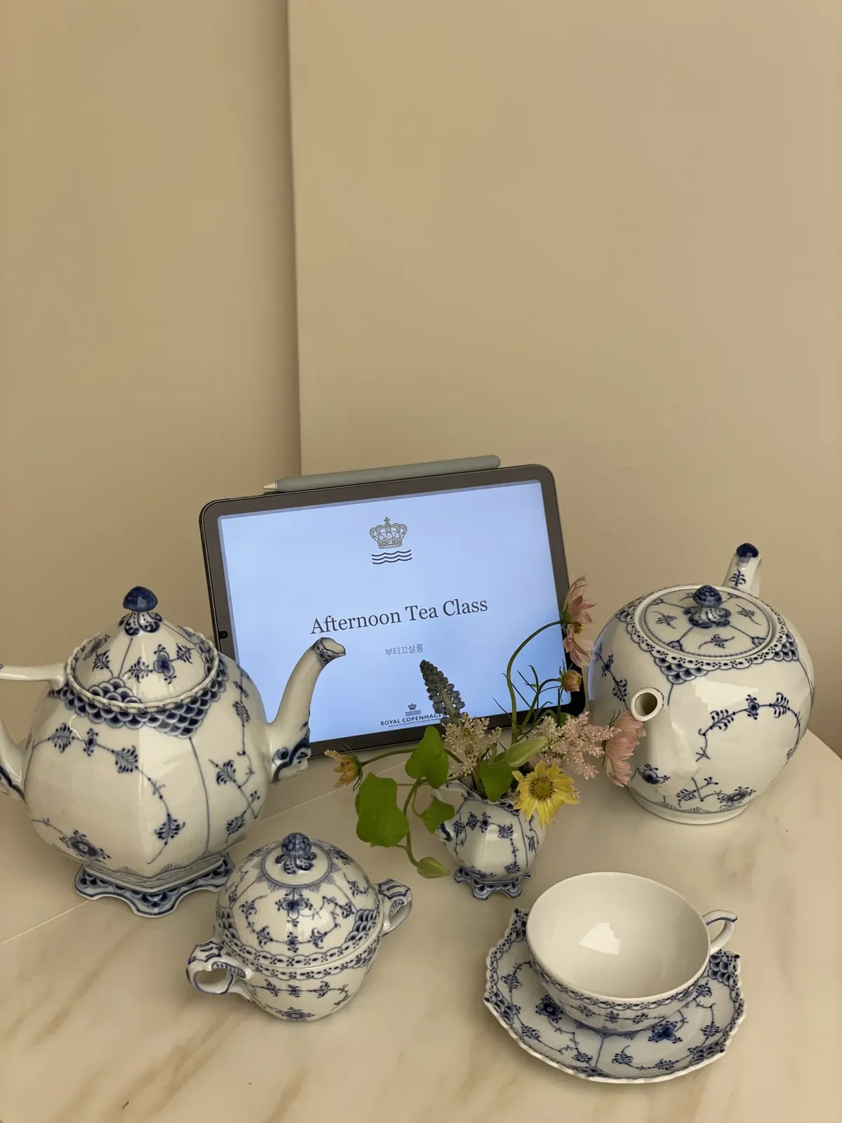 블루 플루티드 티세트와 'Afternoon Tea Class' 문구가 뜬 태블릿 클로즈업